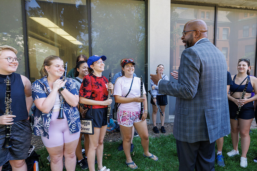 Chancellor Rodney Bennett talks with the clarinet section of the Cornhusker Marching Band during a break in their practice Thursday.