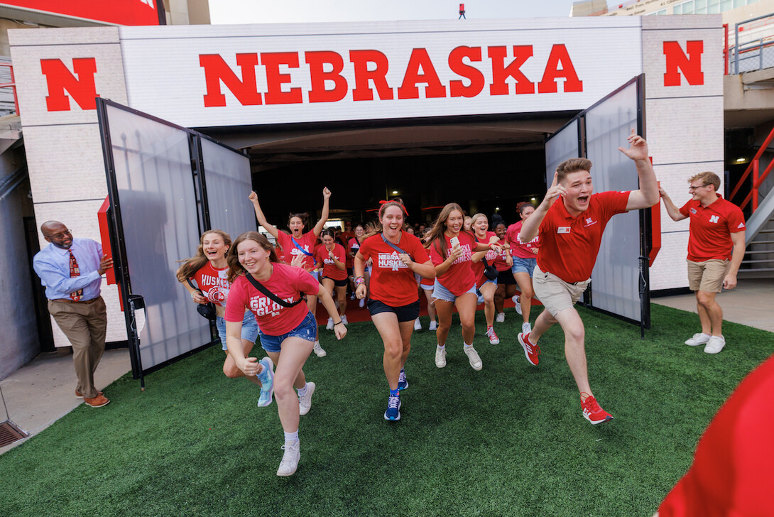 Members of the Class of 2027 lead the group onto the field during the Tunnel Walk in Memorial Stadium.