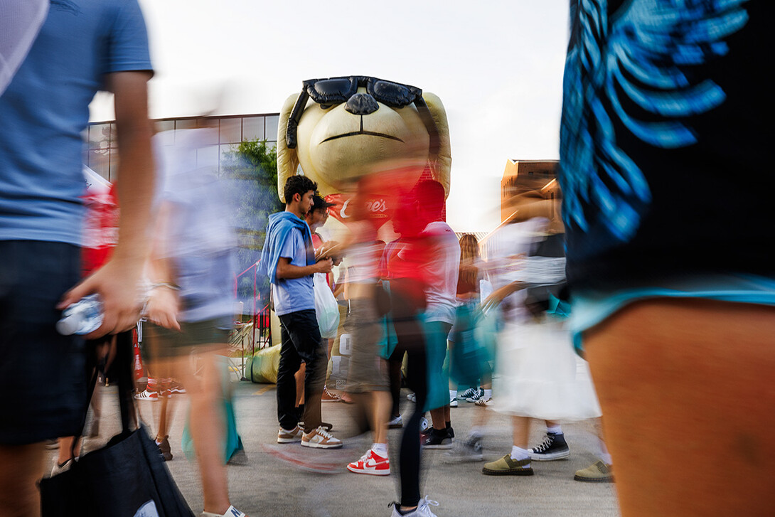 Godzilla Cane watches over the blur of students at the Big red Welcome Street Fest on the Memorial Stadium loop.