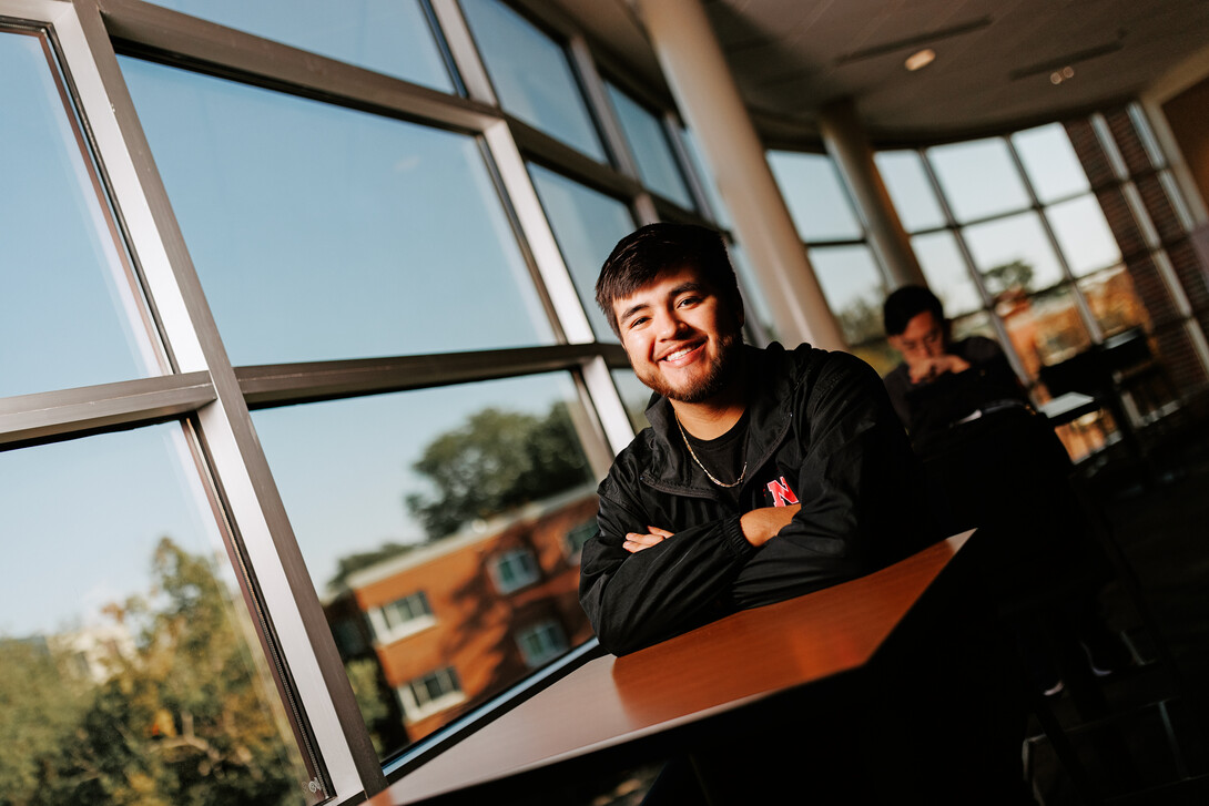 Isaac Perez smiles for a photo in the Jackie Gaughan Multicultural Center