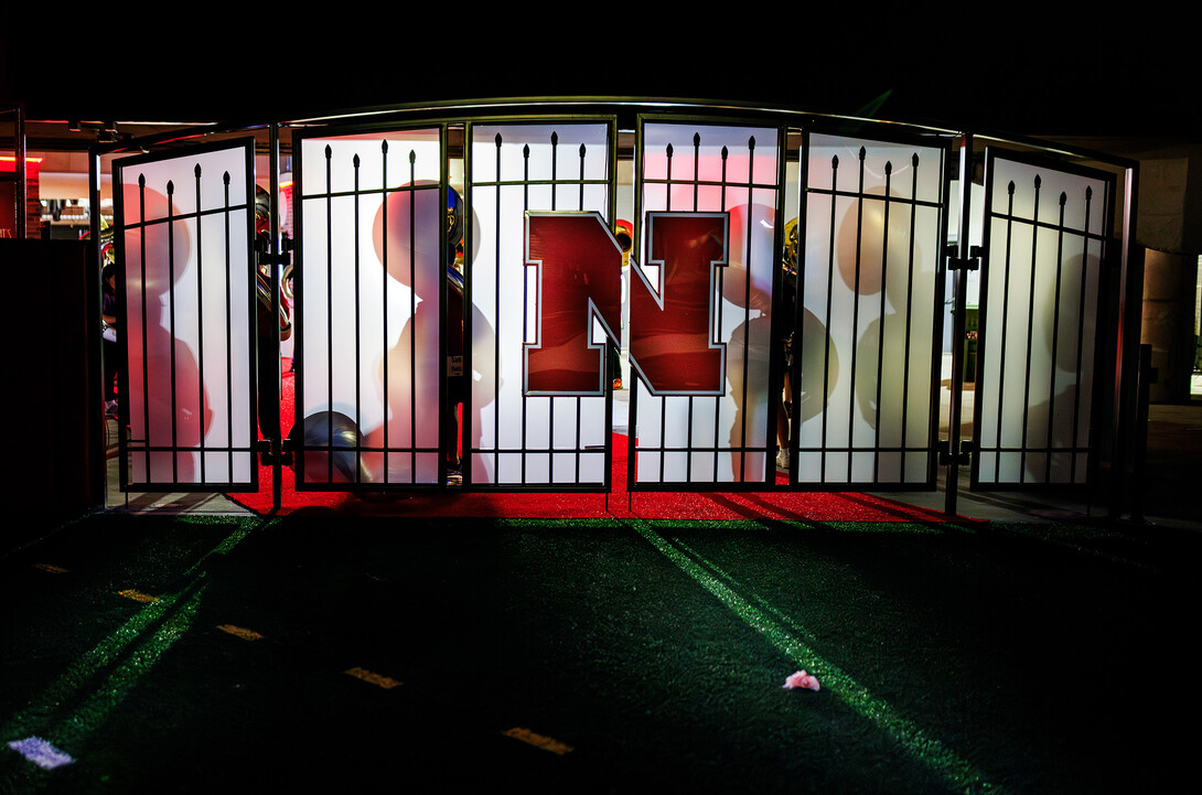 The shadows of the souzaphone players fall on the tunnel walk doors during their 6:30 am section practice.