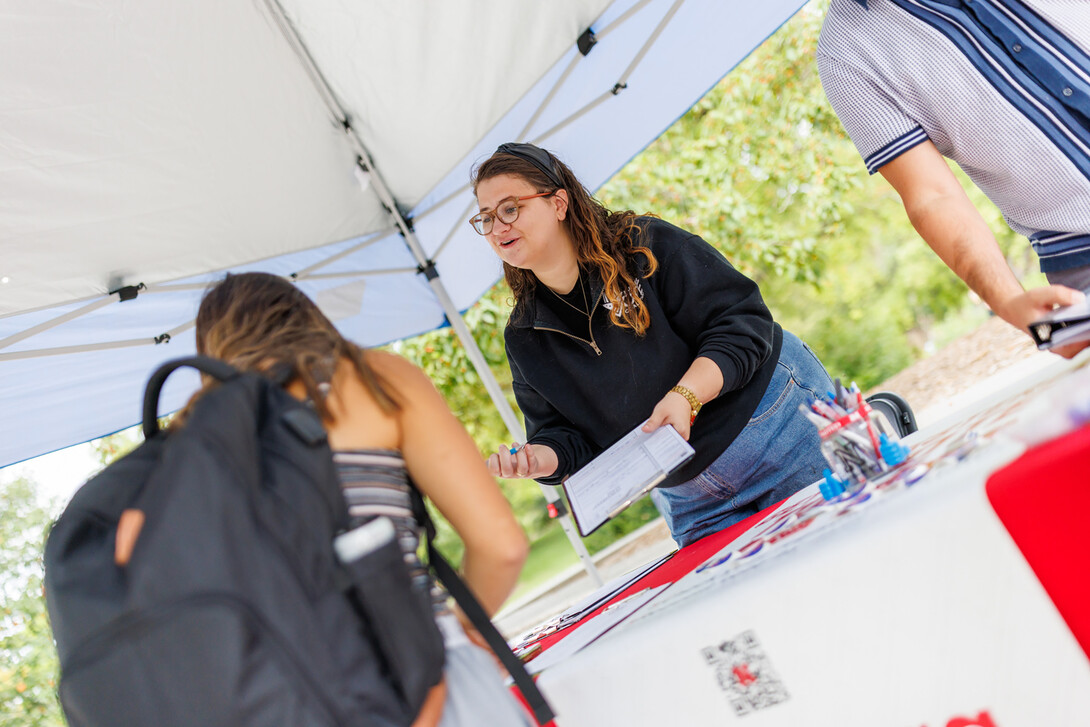 Maggie Nielsen with Husker Vote helps register students on National Voter Registration Day.