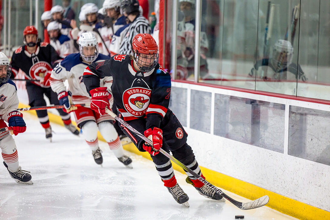 Dylan Mcrae, forward (74), moves the puck down the ice. 