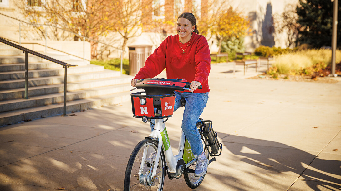 A student rides along R Street on a BikeLNK rental bicycle.