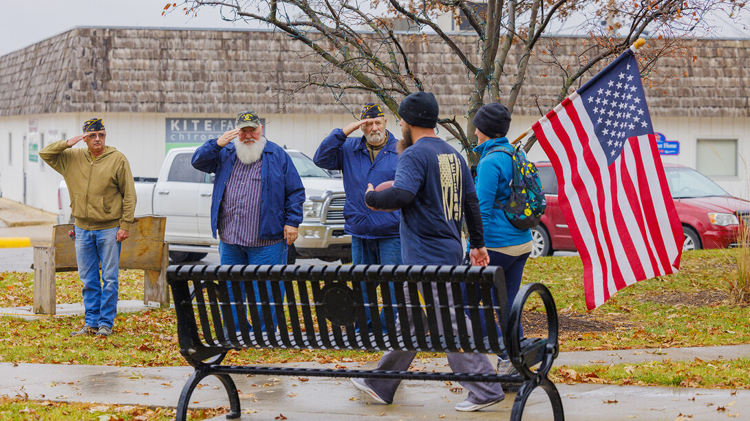 The Veterans Color Guard of Atlantic, Iowa, salute the flag as ruck marchers walk to the finish of the 21-mile morning section of the Nov. 20 march.