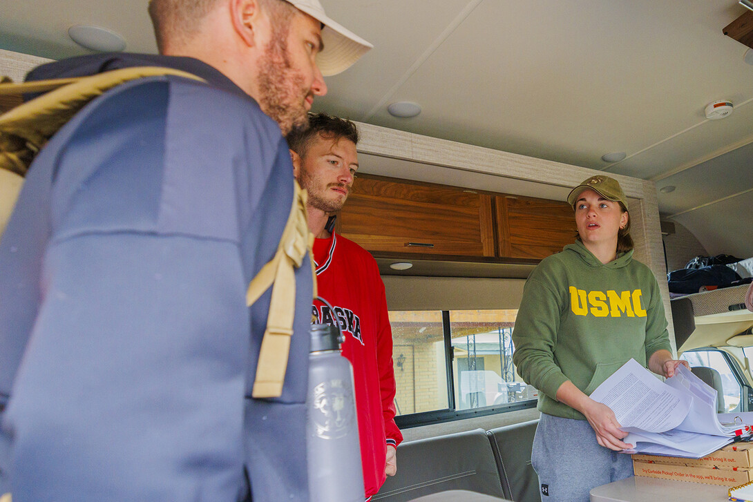 Jenalee Wimer, a senior animal science/pre-veterinary medicine major,  helps Lincoln veterans (left) Pete Lass and McCain Vesa at the start of sign the afternoon session of the march on Nov. 20. Wimer leads is a U.S. Marines veteran from West Point, Nebraska, and president of the UNL Student Veterans of American chapter.