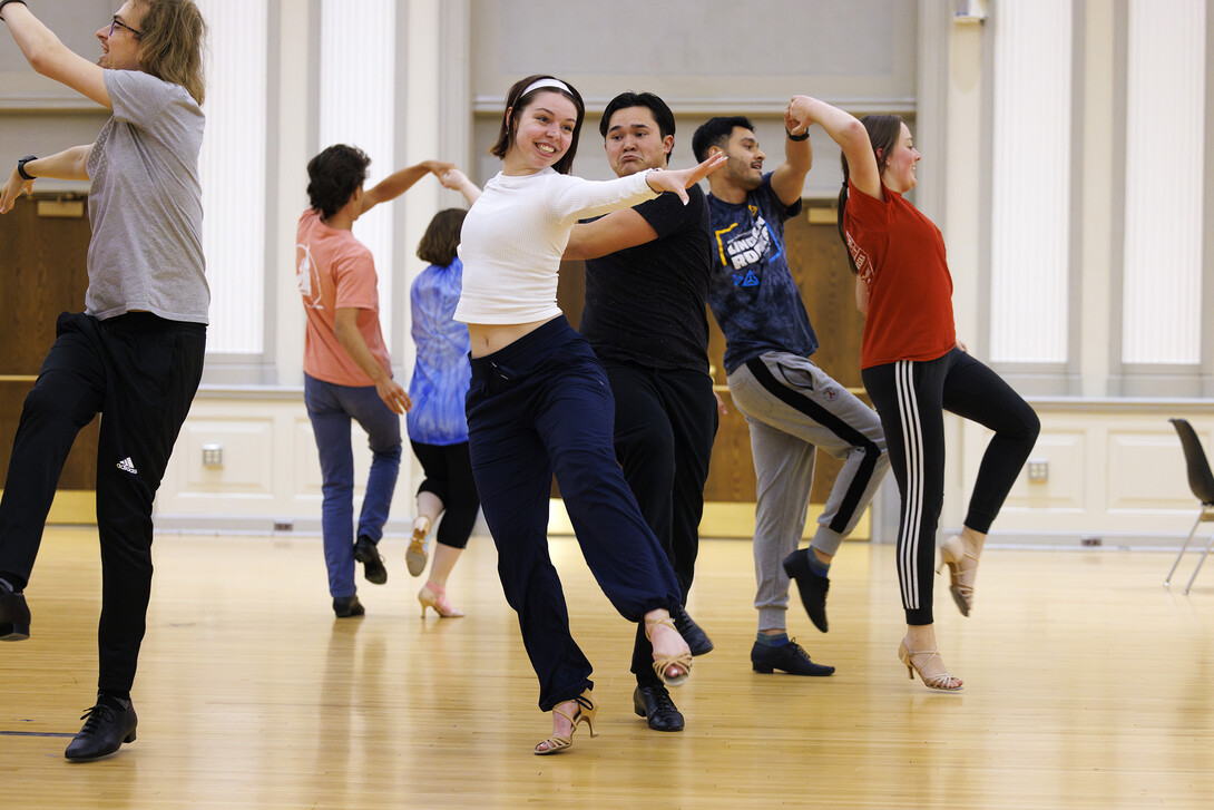 Grace Thomsen and Calen Bernbeck do a quick step dance with the rest of the gold group.