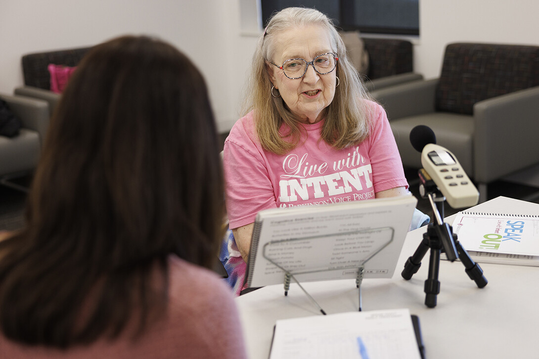 Rhonda Heiserman of Lincoln reads out loud during her clinic session. The instrument measures the decibels of her speech.