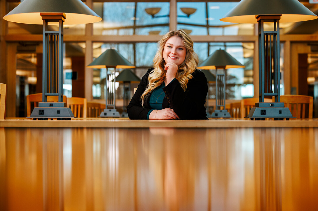 Delaney Doyle poses for a photo in the Marvin & Virginia Schmid Law Library