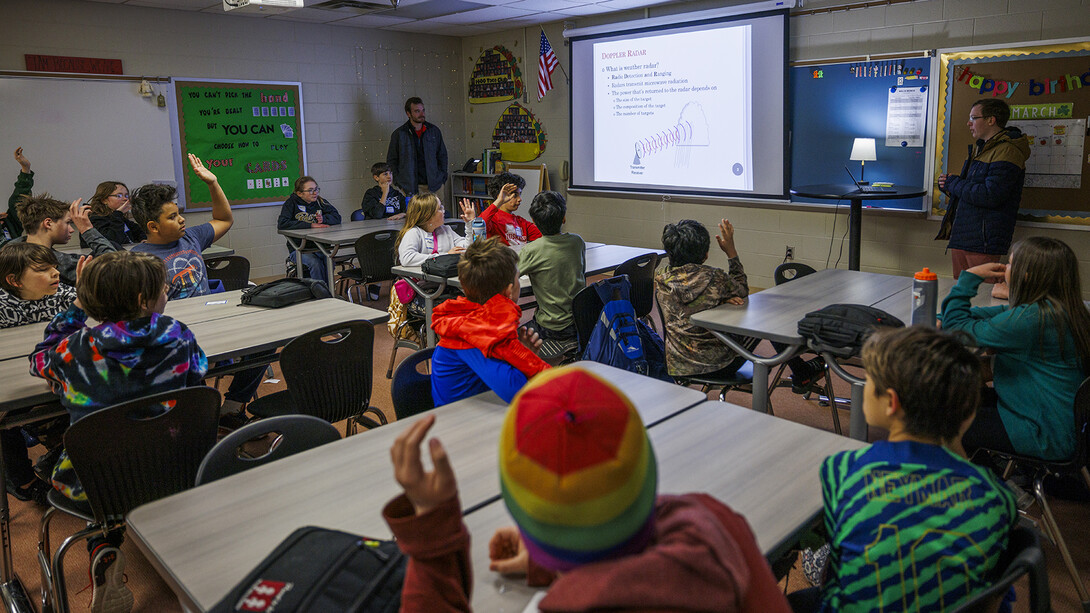 Charles Kropiewnicki, a graduate student in geosciences, talks about weather to the middle school students.