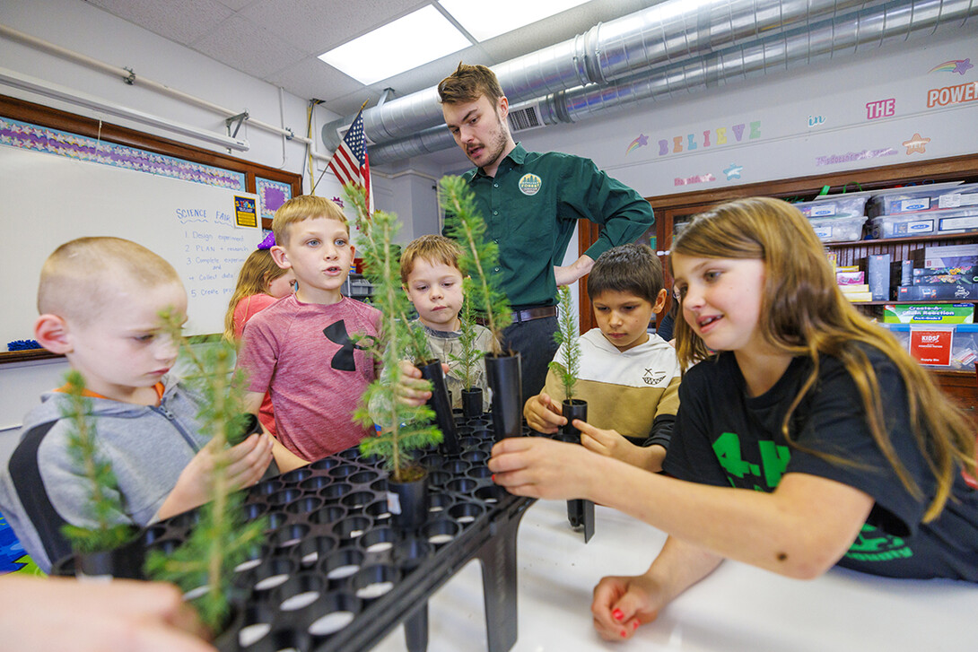 Jack Hilgert, Conservation Education Coordinator for the Nebraska Forest Service, answers second graders’ questions about their new blue spruce seedlings they will be growing in their Humboldt Table Rock Steinauer school classroom in Humboldt, Nebraska.