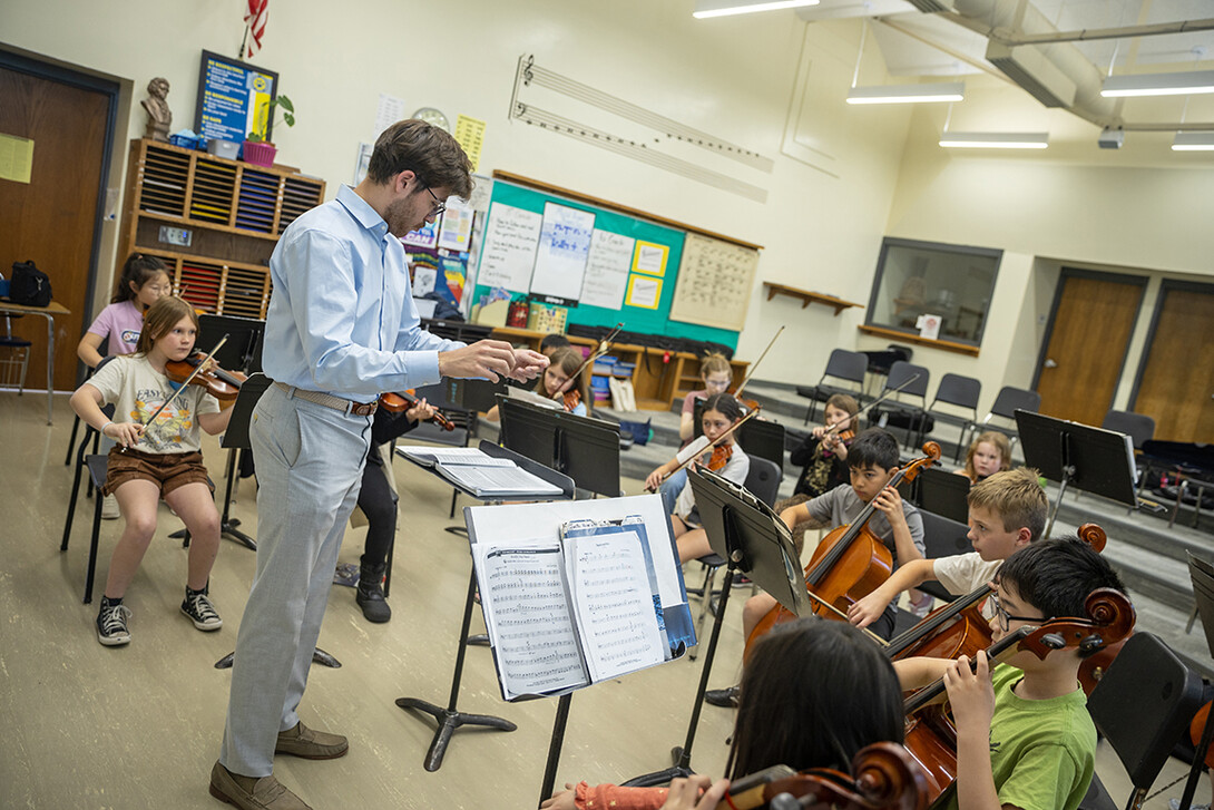 Dameer Gustafson, junior music education major, teaches the UNL/LPS String Project second-year class in preparation for their concert April 17.