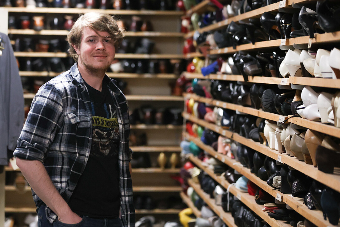 Hunter Rock stands in a costume closet behind the scenes of Nebraska Rep's "Big Fish."