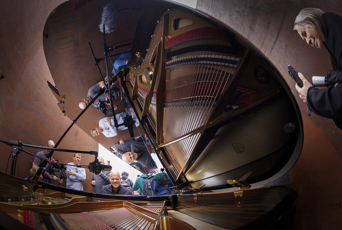 Paul Barnes, Marguerite Scribante Professor of Piano in the Glenn Korff School of Music, is reflected in the piano lid as spectators pass through the sculpture.