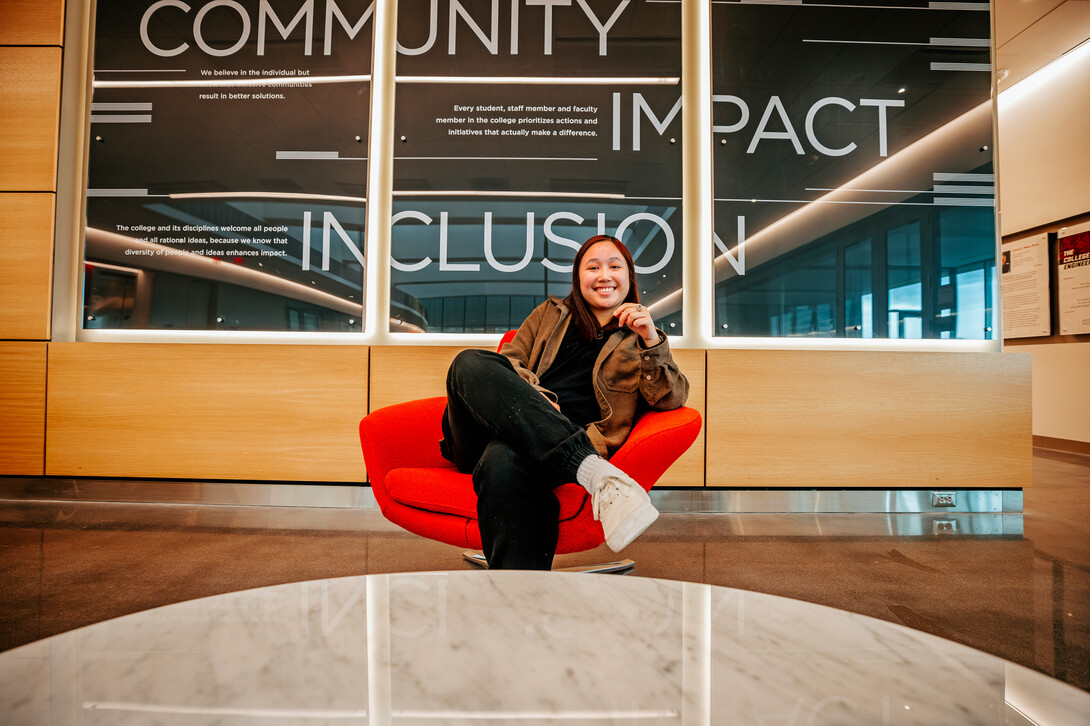 Civil engineering major Kiley Pham smiles for a photo inside Kiewit Hall.