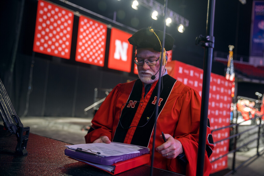 Robert Gorman works on running Graduate Commencement.