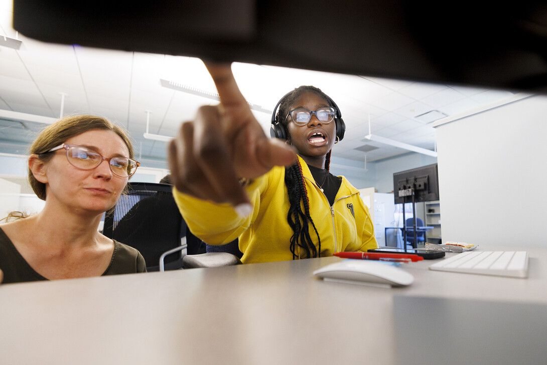 Veronica Sargbah discusses her document with Anne Gregory, a graduate research assistant and participant in the Mellon Foundation-funded program.