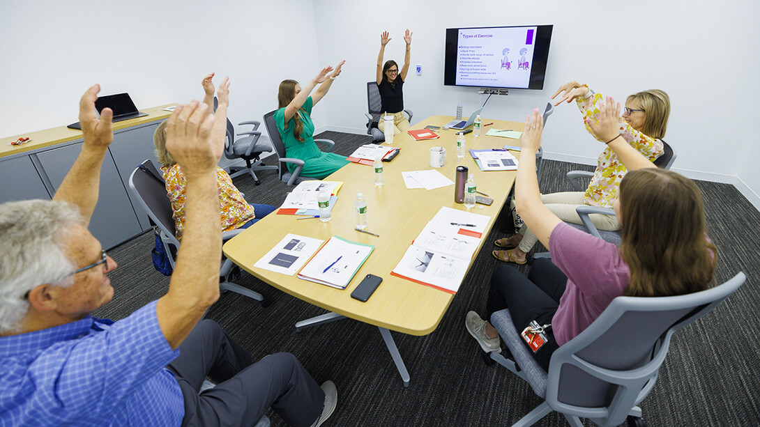 Judy Harvey and participants in the memory workshop go over a set of exercises that can be done while sitting.