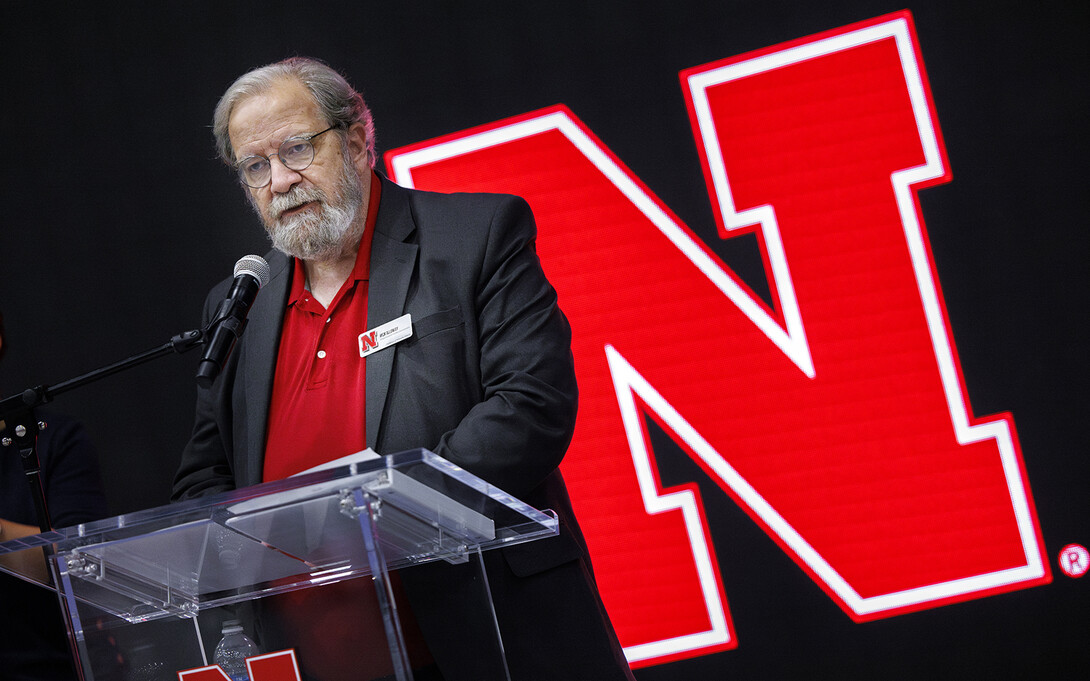 Rick Alloway, a professor in the College of Journalism and Mass Communication, stands at the podium during the Celebration of Service. Alloway has served as emcee for the event for a number of years.