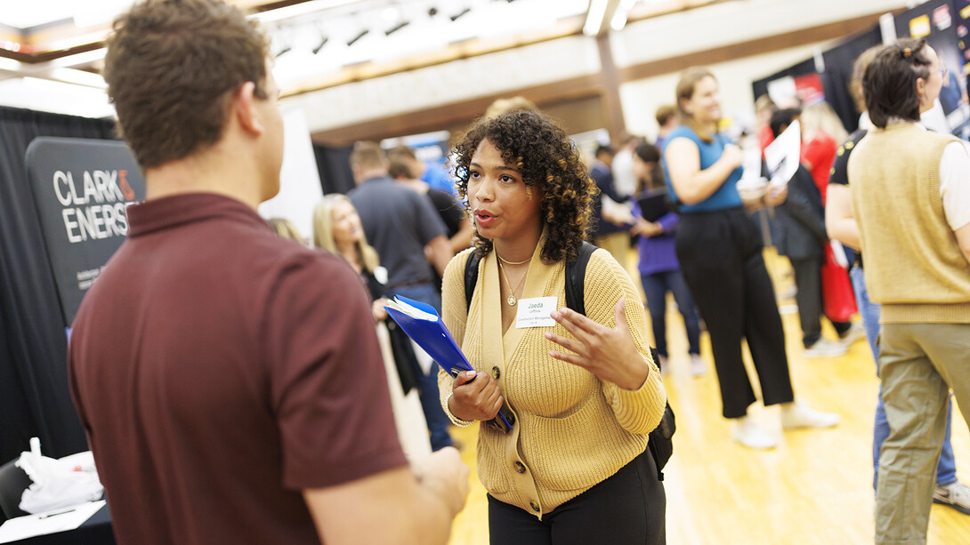 Jaeda Jeffries (right), a junior construction management major, talks with Alex Masek of Brinkman Constructors during the second day of the University Career + Internship Fair on Sept. 17. 