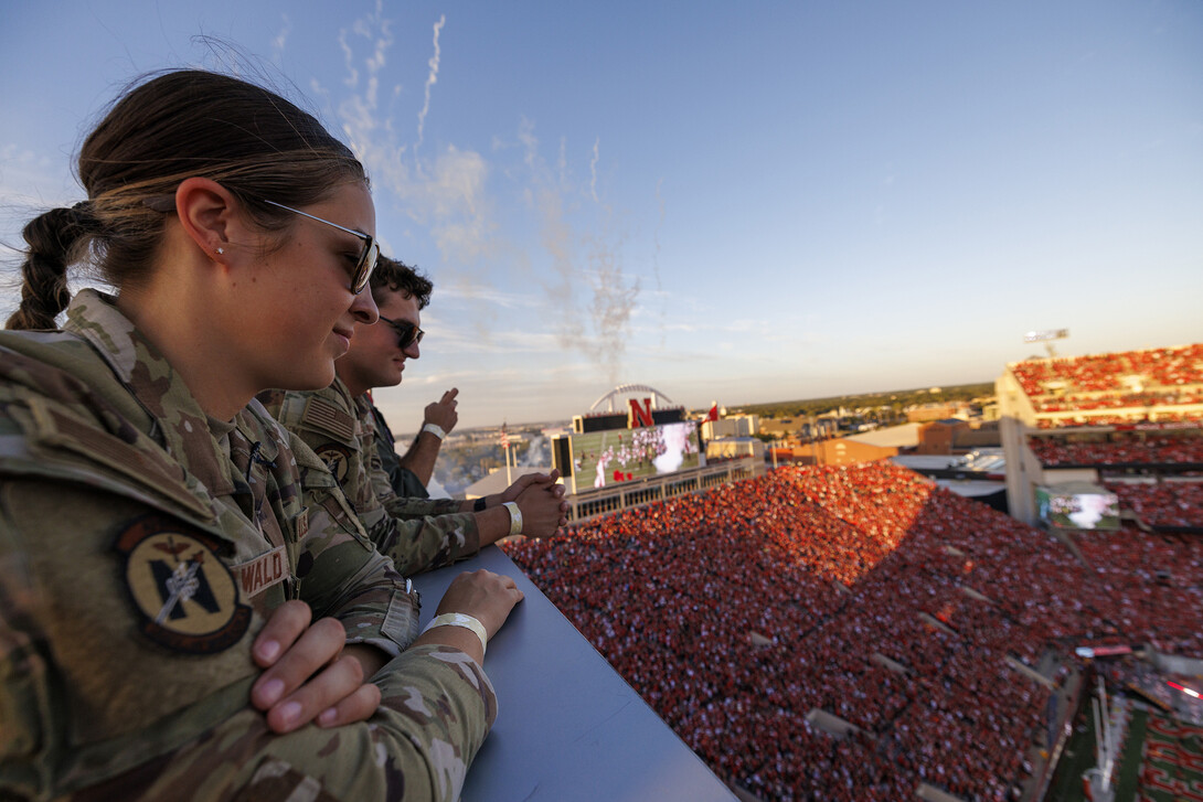 Elena Burgwald (left) and Mason Beck (right) watch the kickoff from the roof of Memorial Stadium.