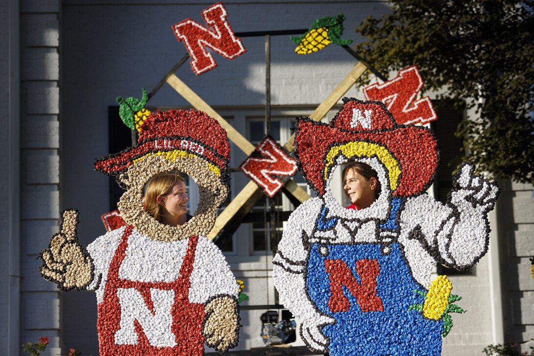 Sydney Honaker and Abby Veiman try out the Lil Red and Herbie lawn decorations in front of the Phi Kappa Psi fraternity house during Homecoming festivities Oct. 4.