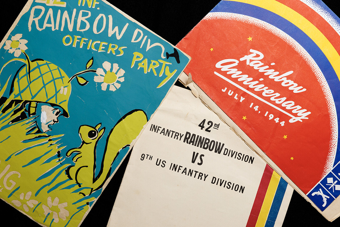 Various programs from the Rainbow Division are photographed.