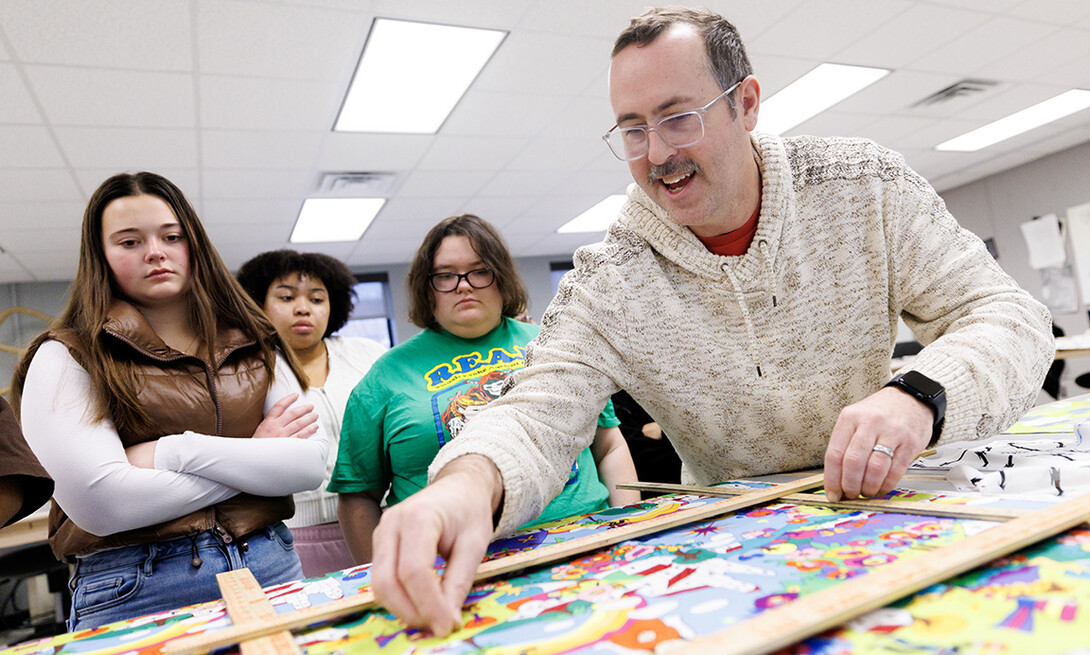 Michael Burton, assistant professor in the Department of Textiles, Merchandising & Fashion Design, identifies a pattern in a textile during his Advanced Design for Printed Textiles class inside the Gwendolyn A. Newkirk Human Sciences Building.