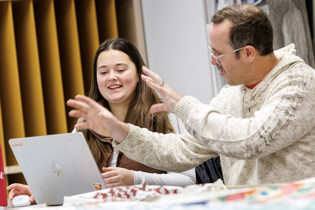 Jaxon Gilner, left, senior, talks with Michael Burton, assistant professor in the Department of Textiles, Merchandising & Fashion Design, about her pattern design during their Advanced Design for Printed Textiles class inside the Gwendolyn A. Newkirk Human Sciences Building.