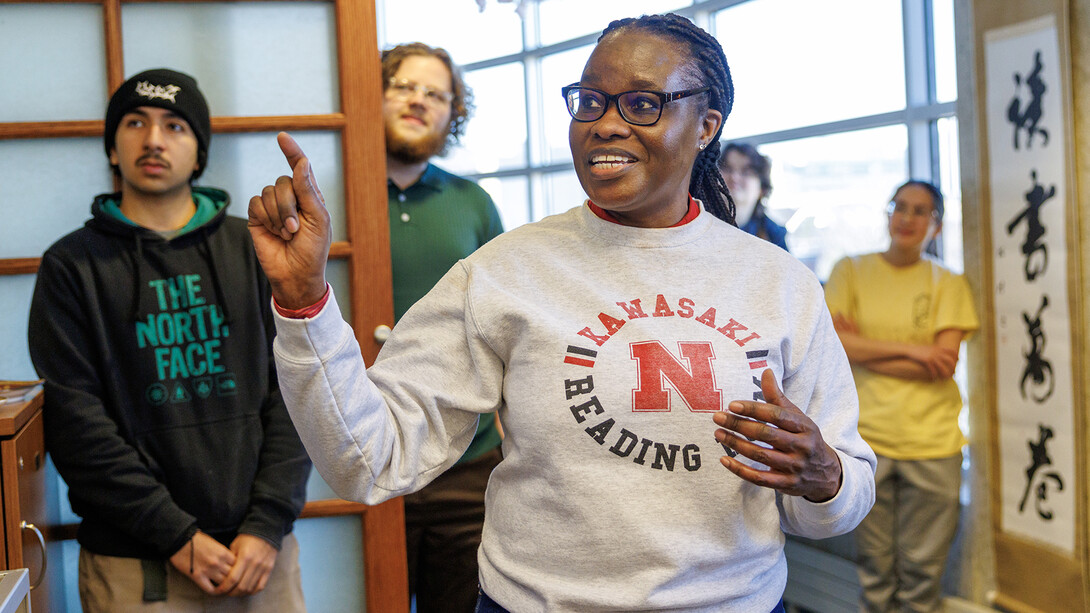 Cheryl Muregerera, a Kawasaki Reading Room worker and graduate student in educational administration, talks about the bean-throwing ritual tradition and its purpose at the start of the mamemaki event.