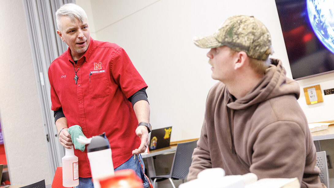 Cory Densberger talks with Chad Schollmeyer, a junior business administration major, in the Nebraska Union food court on Feb. 7.