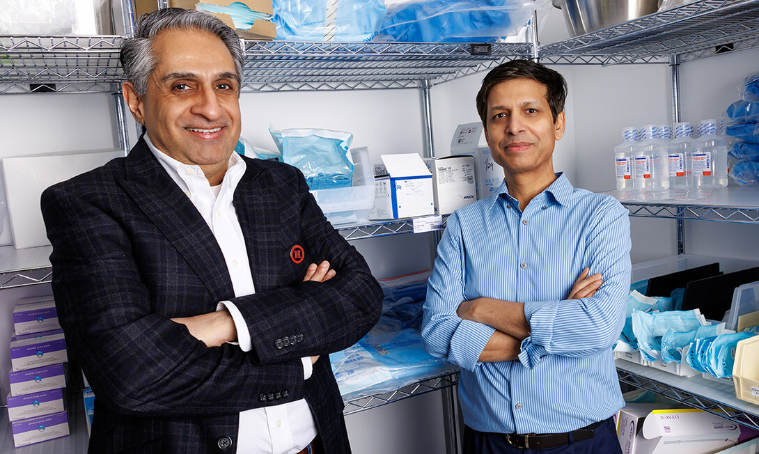 Amit Saini, left, and Alok Kumar, professors in the Department of Marketing at the College of Business, stand next to medical supplies inside the Nebraska Medicine University Health Center. Saini and Kumar explore how group purchasing organizations can enhance supply chain efficiency and reduce patient care costs. 