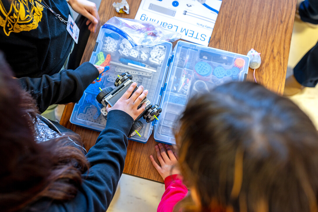 Lincoln High School students look through a VEX Robotics kit.