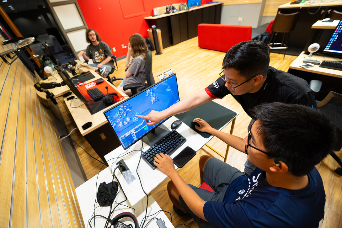 yan Tan, assistant professor in the College of Journalism and Mass Communications and UNL esports director, coaches Tony Wang on playing StarCraft. Wang, a high school sophomore from Lincoln, is one of four students in the Big Red Summer Camps esports camp. He signed up for the camp interested to learn more about building his own computer and esports content generation.