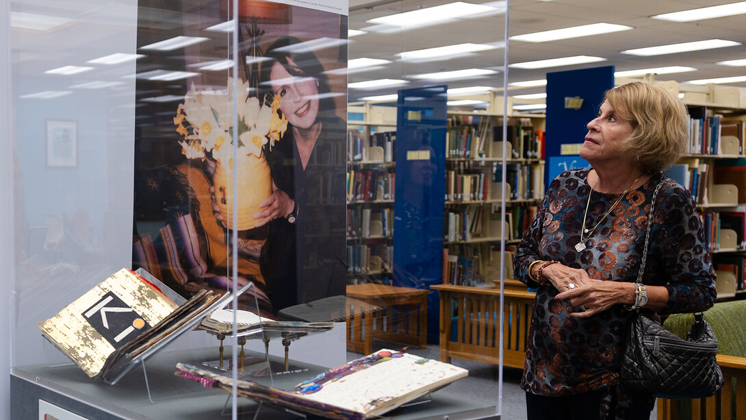 Jeanne Clinker, a 1970 University of Nebraska–Lincoln graduate, explores “The Muck, the Seeds, the Weeds, the Blossoming: The Journals of Karen Blessen,” an exhibition in Love Library.
