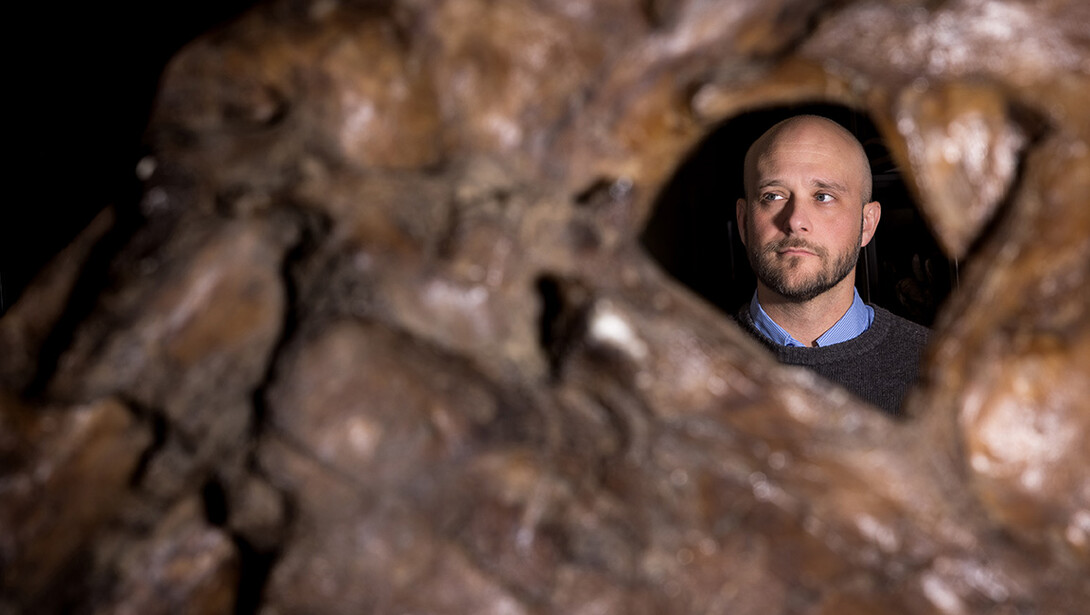 shley Poust, Curator- Vertebrate Paleontology for the University of Nebraska State Museum, stands behind a cast of the upper jaw of a Tyrannosaurus rex, one of the largest specimens known. 