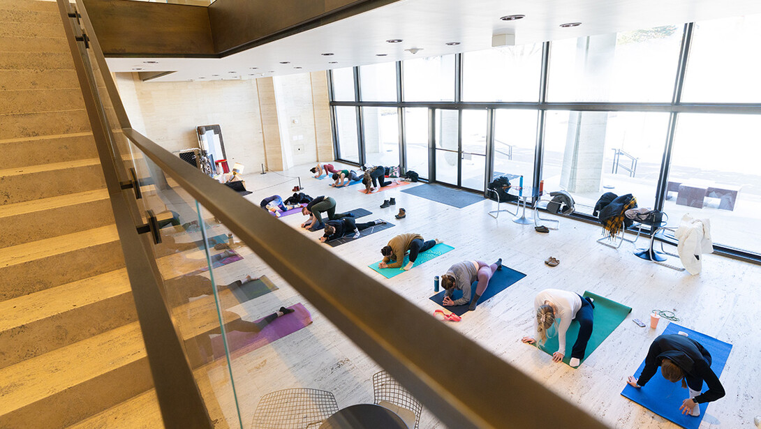 Coats and scarves drape chairs behind participants during Yoga at the Sheldon on Jan. 25. The event was hosted by both the museum and Campus Recreation, and drew about 40 participants, despite subzero temperatures outside.