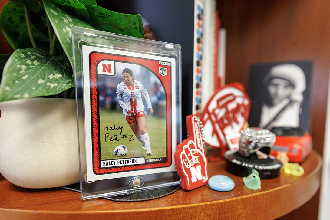 A trading card of Andrea Peterson’s daughter, Haley Peterson, sits on a shelf inside her office in Old Father Hall. Haley played four years for the Huskers’ soccer team from 2021-2024.