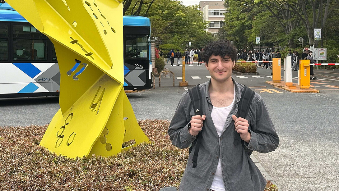 MJ Jabbar in front of a sculpture at the main entrance of Saitama University in Saitama, Japan.