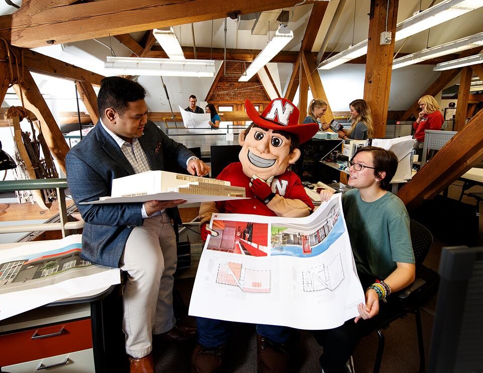 Herbie Husker examines building plans in an Architecture Hall lab space. This image is part of the Nebraska Alumni Association's 2018 calendar.