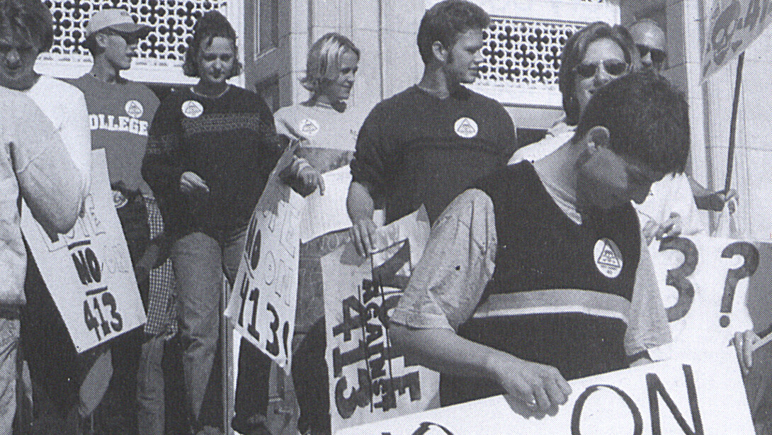 Nebraska students stand on the steps of the Nebraska Union during a protest of Initiative 413 in this image from 1999. The measure, which failed, proposed to reduce government spending by limiting the amount of tax revenue available for state and local governments to spend. This protest was organized by the Association of Students of the University of Nebraska.