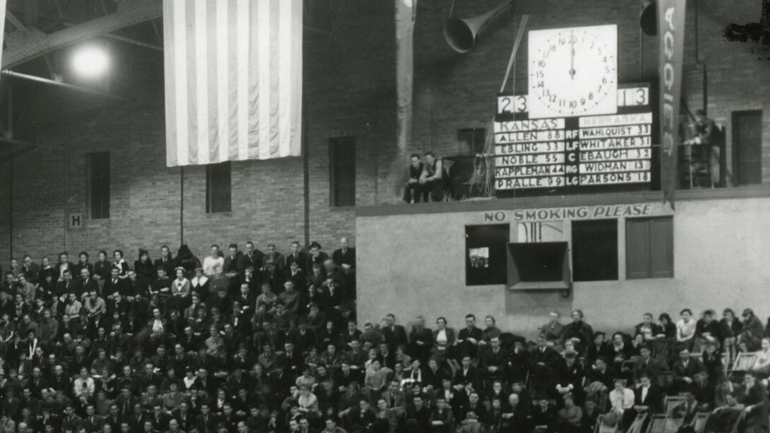 Detail of the Coliseum scoreboard, which featured the last names of the starting five for each team and a halftime score of 23-13 in favor of the Jayhawks.