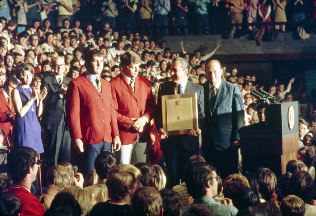 President Richard Nixon honored the Huskers 1970 national championship football team with the presentation of a presidential plaque during a Jan. 14, 1971 celebration in the Coliseum. Nixon (holding the plaque) presented the award to (from left) team captains Jerry Murtaugh and Dan Schneiss, and to head coach Bob Devaney.