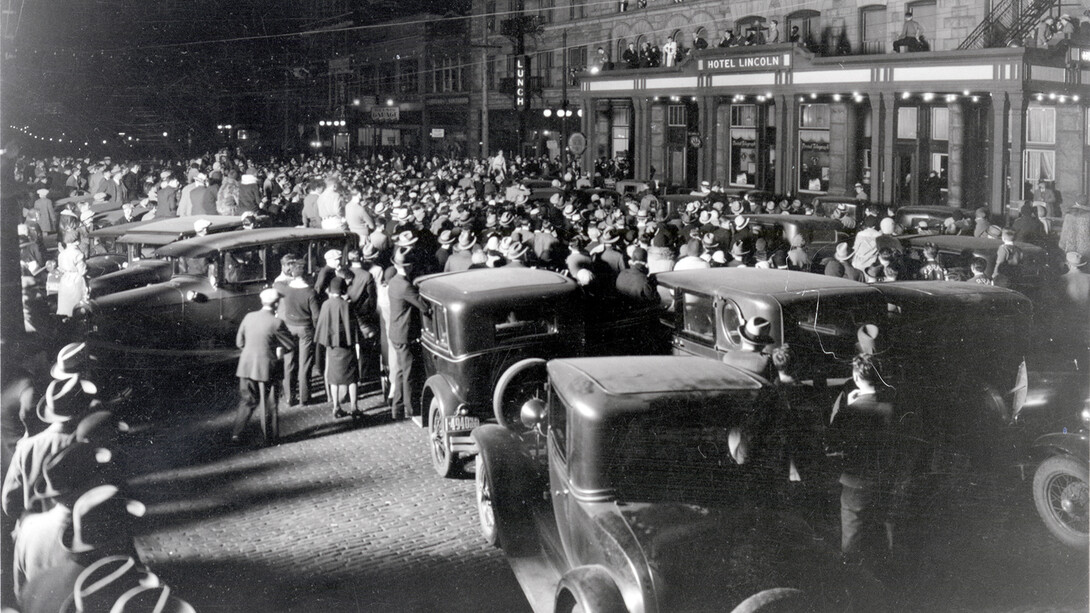 Husker fans gather outside the Hotel Lincoln the night of Nov. 14, 1930 ahead of a Big Six football matchup between Nebraska U and Missouri.