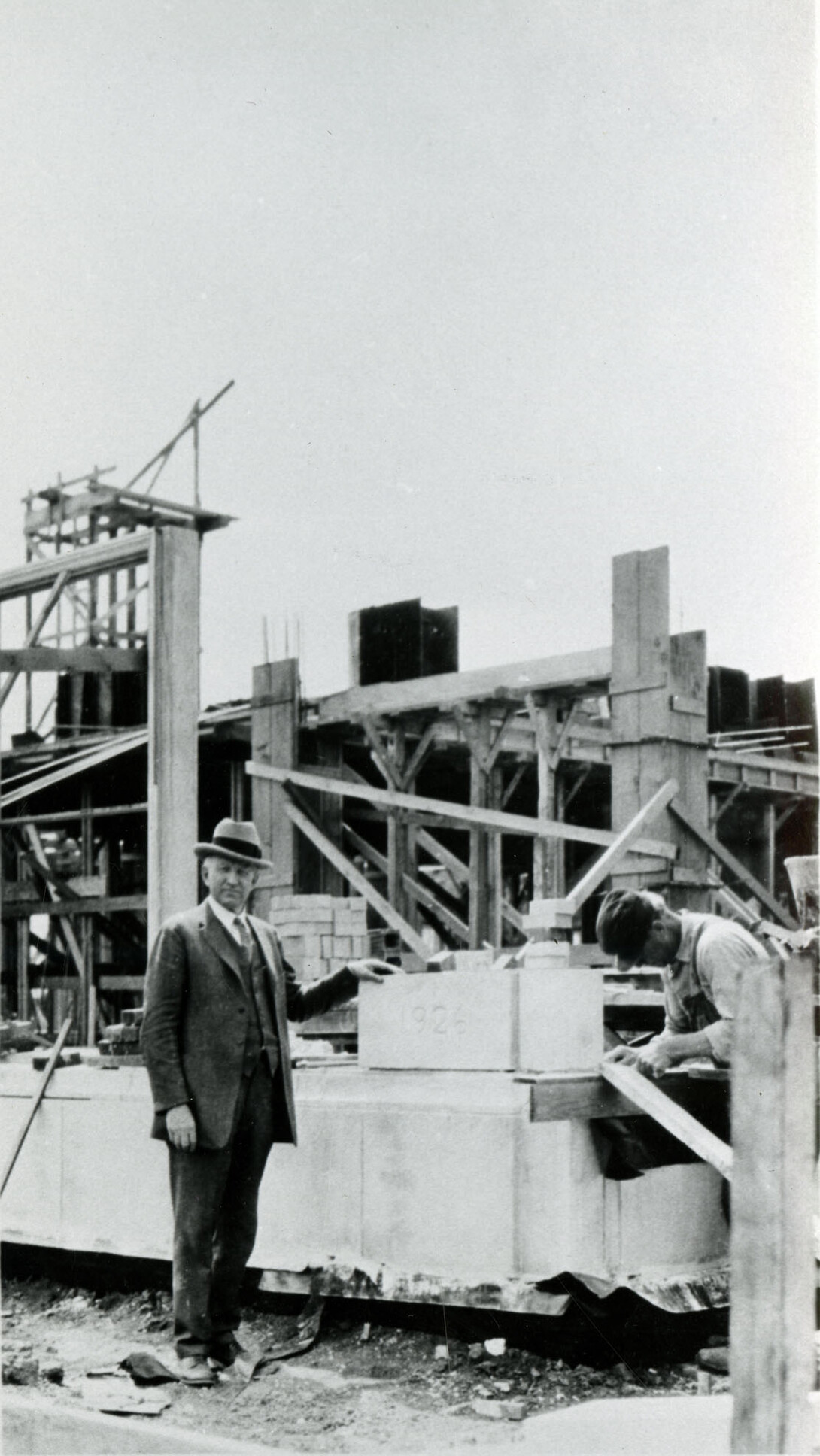 Edgar Burnett stands next to the cornerstone for Burnett Hall.