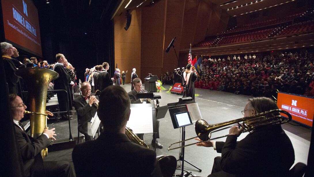 Jamie Reimer sings while the University of Nebraska Brass Quintet plays the National Anthem at the start of the installation ceremony for Chancellor Ronnie Green. The event was April 6 at the Lied Center for Performing Arts.