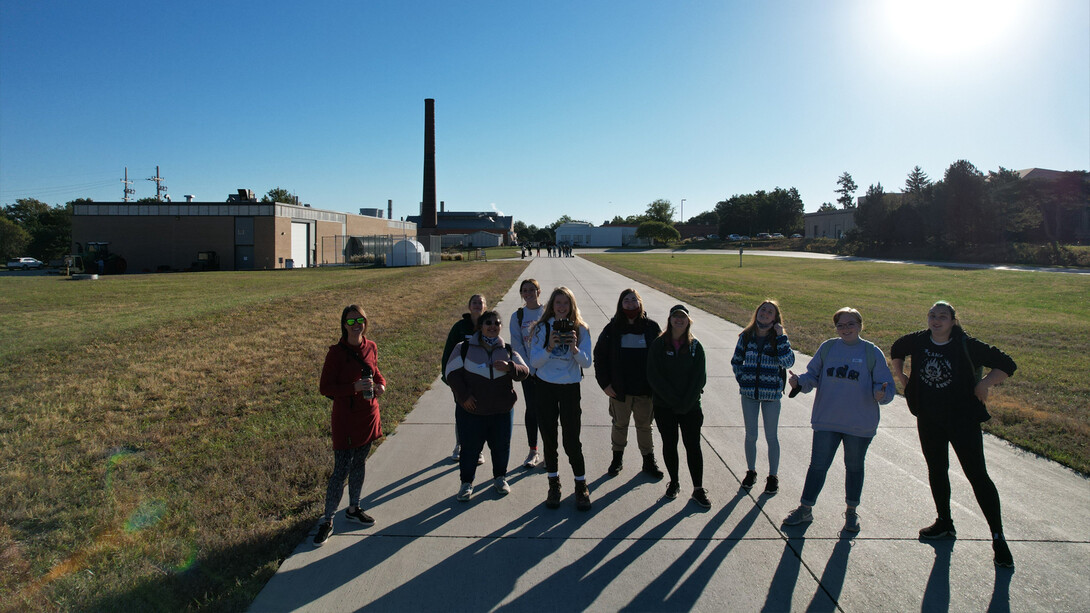 Students stand on the tractor test track on East Campus.