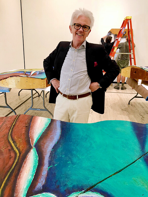 Wally Mason is seen with Elizabeth Murray's "Wishing for the Farm," shown in three parts during installation.