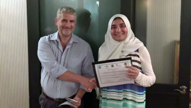 Zahmeeth Sakkaff, graduate student in computer science and engineering, accepts the Best Paper award during the ACM NanoCom conference.