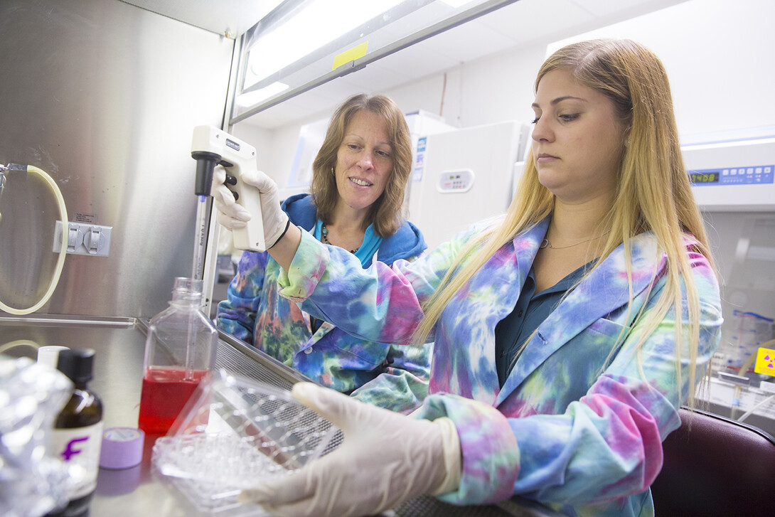 Melanie Simpson (left) supervises doctoral student Abby Gelb, a trainee in UNL's NIH-funded Molecular Mechanisms of Disease program. 